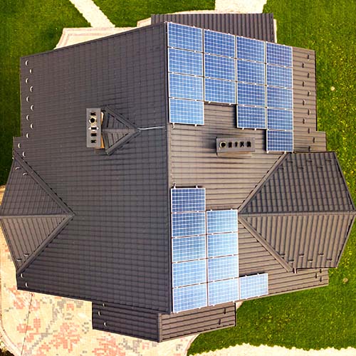 Aerial view of a rural private house with solar photovoltaic pan